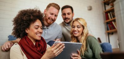 Group of friends holding a tablet
